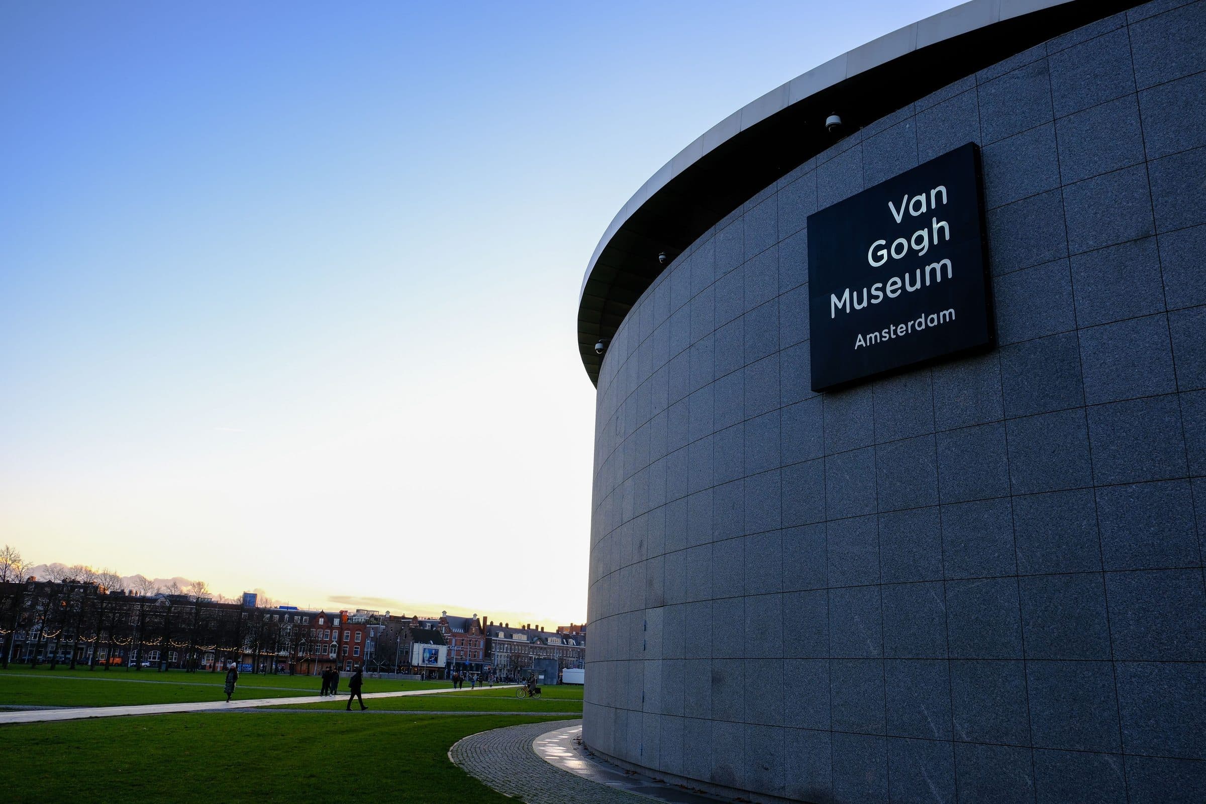 Vista externa do Museu Van Gogh em Amsterdã com parque verde e céu azul