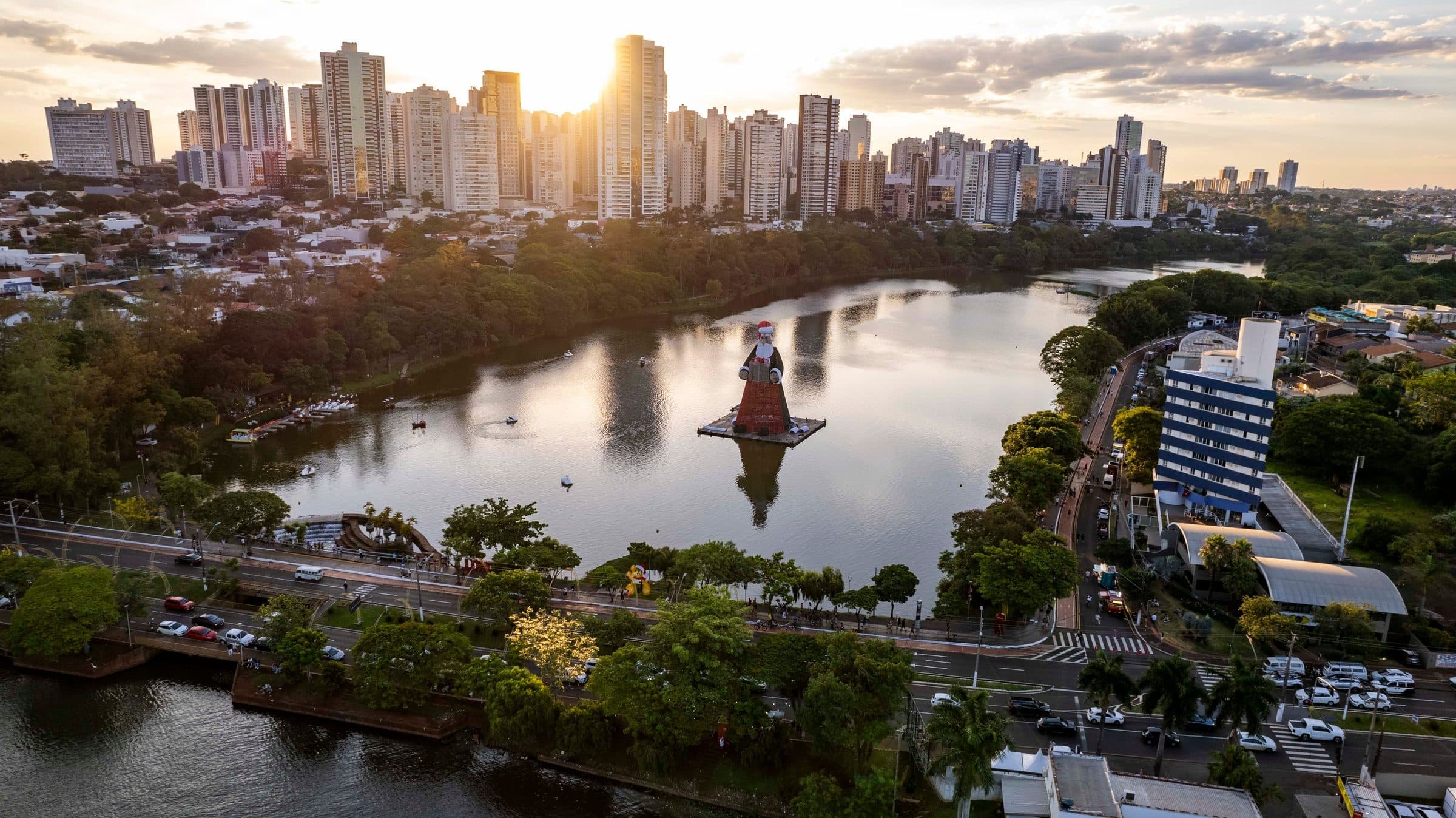 Vista aérea do Lago Igapó em Londrina com a silhueta da cidade ao pôr do sol