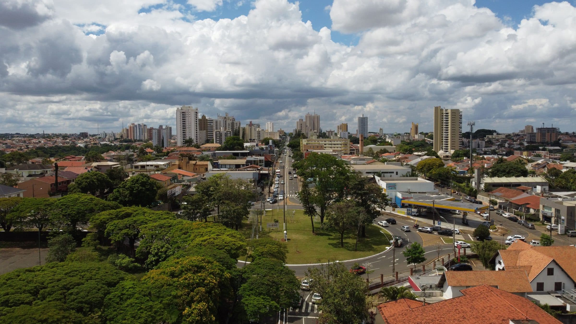 Vista aérea de Londrina com prédios da cidade e áreas verdes sob céu com nuvens